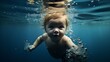 A baby swimming under the water in a pool