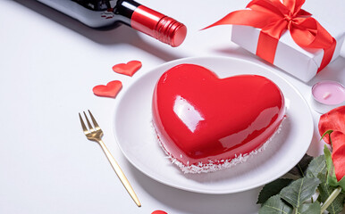 heart shaped glazed valentine cake, gift and champagne on white background