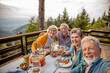 © Marko Geber - Happy senior people taking selfie on mountain cabin deck