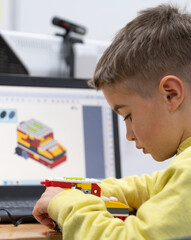boy building a robot in robotics class