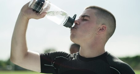 Sticker - Sport, exercise or athlete in drinking water in stadium, thirsty or rugby commitment for training. Man, drink and health in bottle of aqua, cardio workout and energy or strong for competition fitness