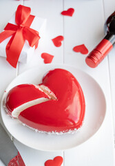 Wall Mural - heart shaped glazed valentine cake and flowers on wooden table