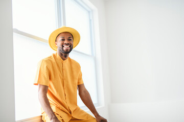 young adult american man standing at home background with fashion clothes