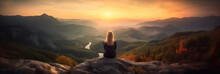 Young Woman Sitting On A Ledge Of A Mountain And Enjoying The Beautiful Sunset Over A Wide Valley. 