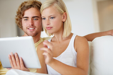 Poster - Smile, tablet and young couple on sofa browsing on social media or internet at apartment. Relax, digital technology and happy man and woman from Australia scroll on website in living room at home.