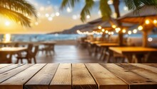 Wooden Table And Blur Beach Cafes Background With Bokeh Lights High Quality Photo