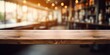 Blurred coffee shop background with an empty wooden table for product display.