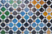 colored mosaic tiles on the wall of the Alhambra palace in Granada, Andalucia, Spain