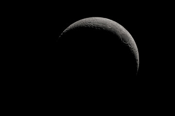 Wall Mural - crescent moon photographed with a telescope, where you can see the craters and the lunar surface, it