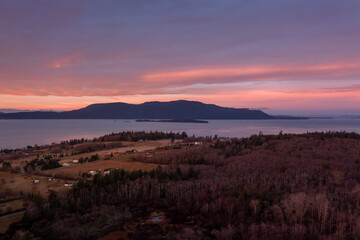 Aerial View of Sunrise Over Orcas Island, Washington. Located in the Salish Sea, Orcas Island is seen from Lummi Island across the Rosario Strait in the San Juan Island archipelago.