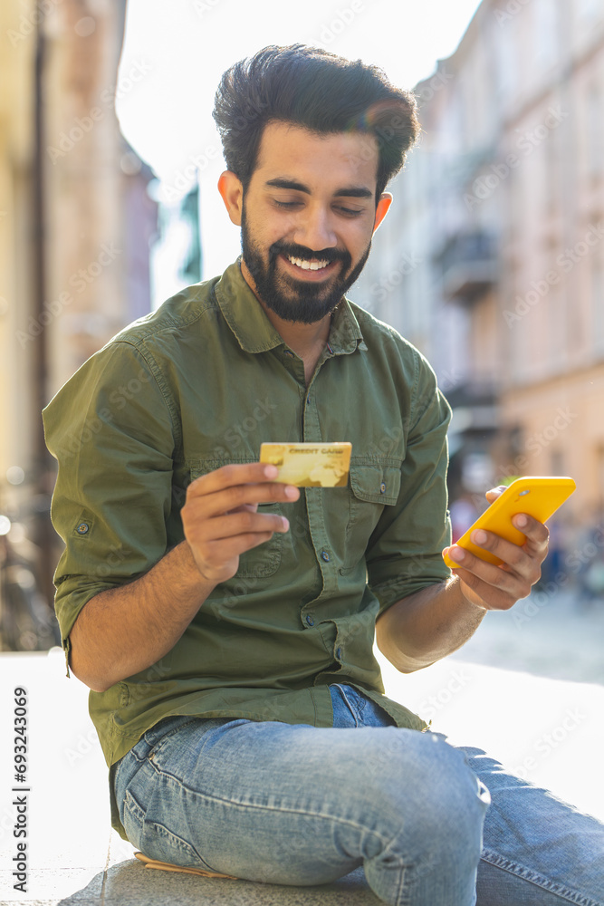Indian man using credit bank card smartphone while transferring money ...