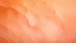 Closeup of a Peach Fuzz colored backdrop featuring a gradient effect with lighter and darker shades.
