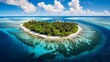 An aerial view of a coral atoll with clear turquoise waters, white sandy beaches, and lush greenery.