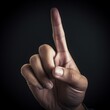 © Naige - Close up of a man's hand forefinger pointing something on dark background. Concept Business / Command / Power / Leader