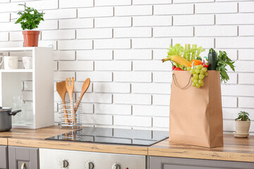 Sticker - Paper bag with different products and utensils on counter in kitchen