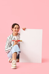 Poster - Young woman with paint brush and blank poster on pink background