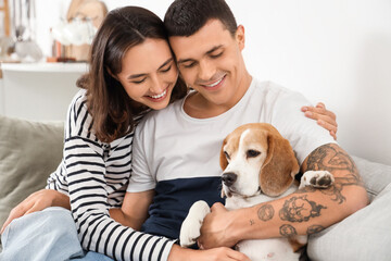 Poster - Young couple with cute Beagle dog at home