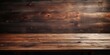 Dark wooden table or plywood with textured planks.