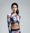 Fitness woman in sportswear on gray background, asian beauty