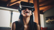 © Jammer Gene - Young woman wearing VR goggles indoors. Happy and enjoying virtual movie.