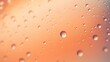 Drops of water, dew or rain on a peach-colored background.