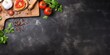 Food recipe concept with a pizza or bread cutting board on a table. Panoramic top view with stone background texture and copy space.
