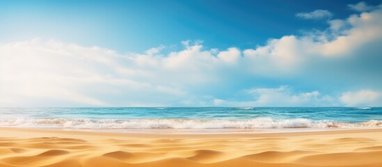 Wall Mural - Summer beach blur defocused background. tropical with golden sand, turquoise ocean blue sky with white clouds on bright sunny landscape for holidays product presentation.