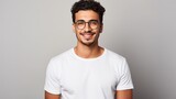 Fototapeta  - Attractive young Mexican man wearing a white t-shirt and glasses. Isolated on white background.