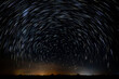 Abstract photo of Blue Night sky star trail background.Startrails on a dark blue sky at night,center sky area.Rotating star lines. The North Star and meteor showers.