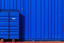 a blue container next to a blue wall