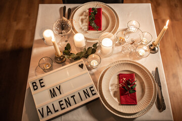 Wall Mural - holidays, valentine's day and celebration concept - close up of festive table serving with be my valentine words on light board at home at night