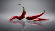 © Maule - Red hot chili pepper on a gray background with reflection, studio shot