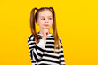 Photo of doubtful unsure little child dressed striped pullover arm chin looking empty space isolated yellow color background