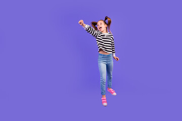 Sticker - Full length photo of positive funky little child dressed striped pullover jumping flying empty space isolated purple color background