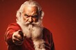 Angry Christmas Santa Claus Pointing his Finger at You on a Red Background with Space for Copy
