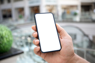 male hand holding phone isolated screen background shopping center airport.
