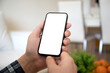 © DenPhoto - male hands hold phone with isolated screen background summer cafe
