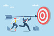 © wenich - Effective teamwork, Successful business development, Setting goals for success or career growth concepts. Team of businessmen grab a big arrow and aim at the target in front of them. Vector design.