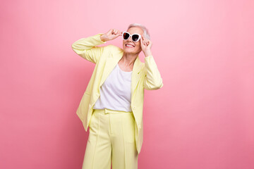 Wall Mural - Photo of fashionista businesswoman wear yellow suit touching sunglasses look novelty accessories boutique isolated on pink color background