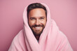 Generative ai photo of handsome positive man wrapped in warm blanket isolated on pink color background