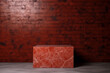 podium red rectangular marble empty table before dark brick wall