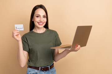 Sticker - Photo of professional buyer mature woman hold credit card expert in ecommerce transactions using netbook isolated on beige color background