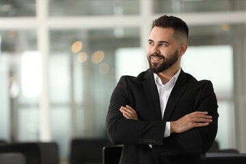 Wall Mural - Portrait of smiling man with crossed arms in office, space for text. Lawyer, businessman, accountant or manager