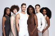 Different races are happily posing side by side in front of a white background