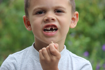 The child lost a tooth. Selective focus.Concept baby tooth