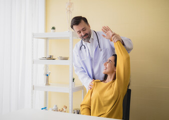 Portrait latin american woman  sick injury with man doctor care caucasian physical therapist two people sitting talk helping support give advice and holding hand arm inside hospital room service