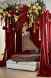 A red bed with a high velvet canopy, with Christmas balls and d cor