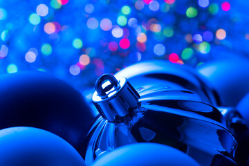Wall Mural - christmas and new year blue color baubles decoration background with colourful lights of garlands. a