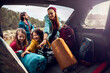 © Marko Geber - Family taking camping gear out of car