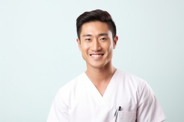 Charming Asian Male Nurse with a Smile - Isolated Image Showing Care, Health and Happiness with Copy Space on the Right